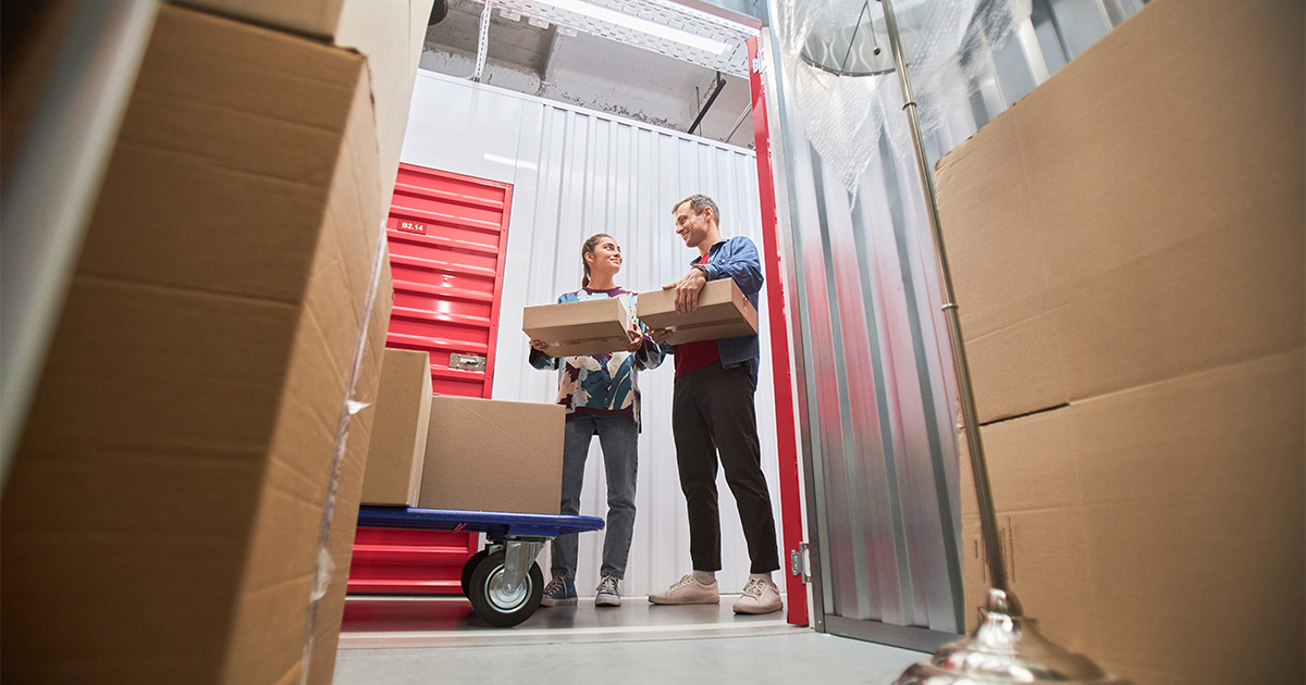 A couple organize and manage a storage unit for their long distance move.