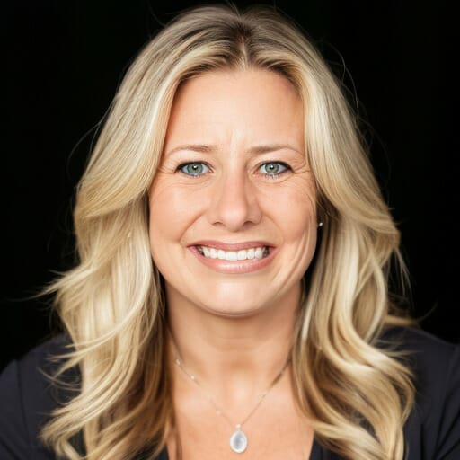 A woman with long blonde hair, identified as Danielle Perri, smiles at the camera against a dark background. She is wearing a dark top and a necklace with a small pendant.