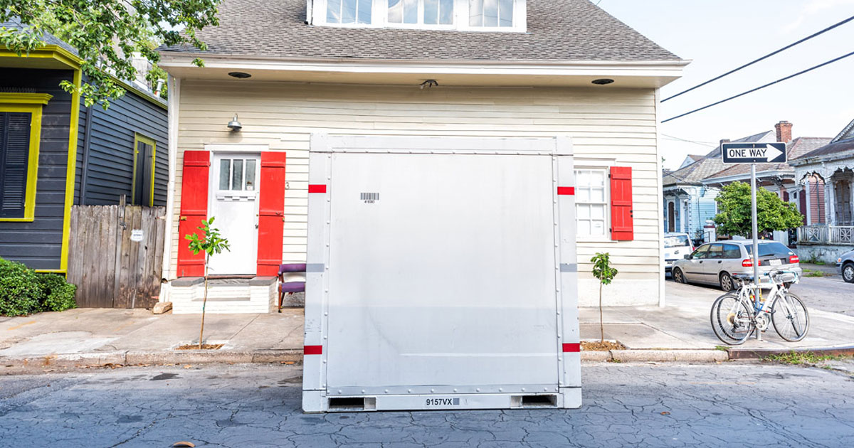 A single moving pod in front of a house. 
