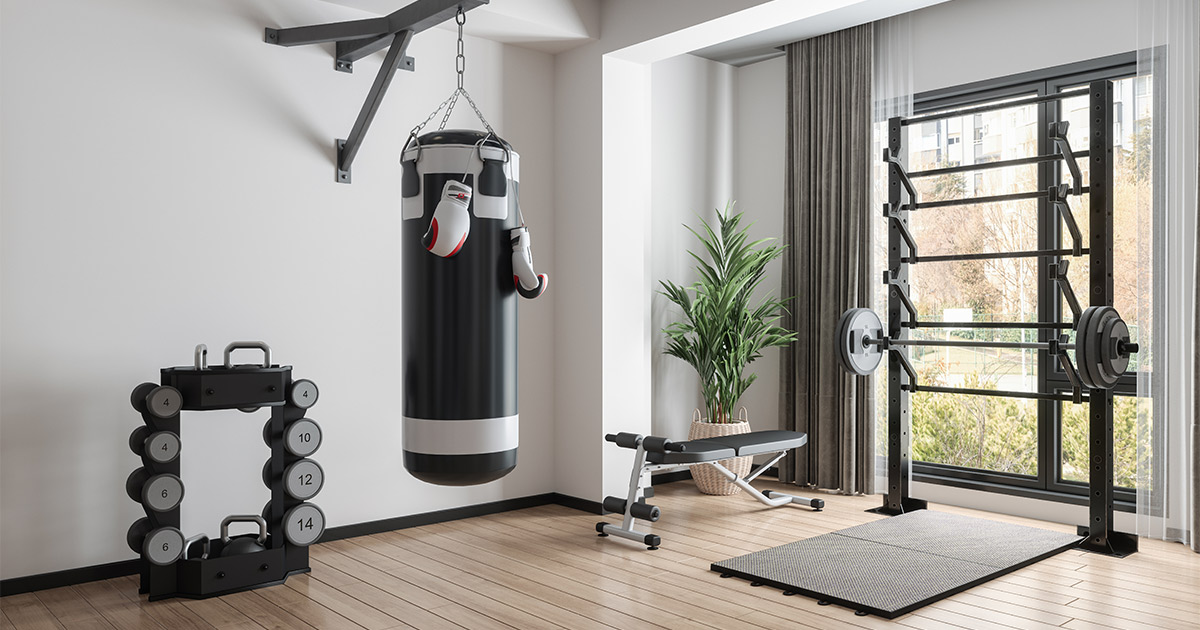A home gym setup, including dumbbells and a heavy bag. 