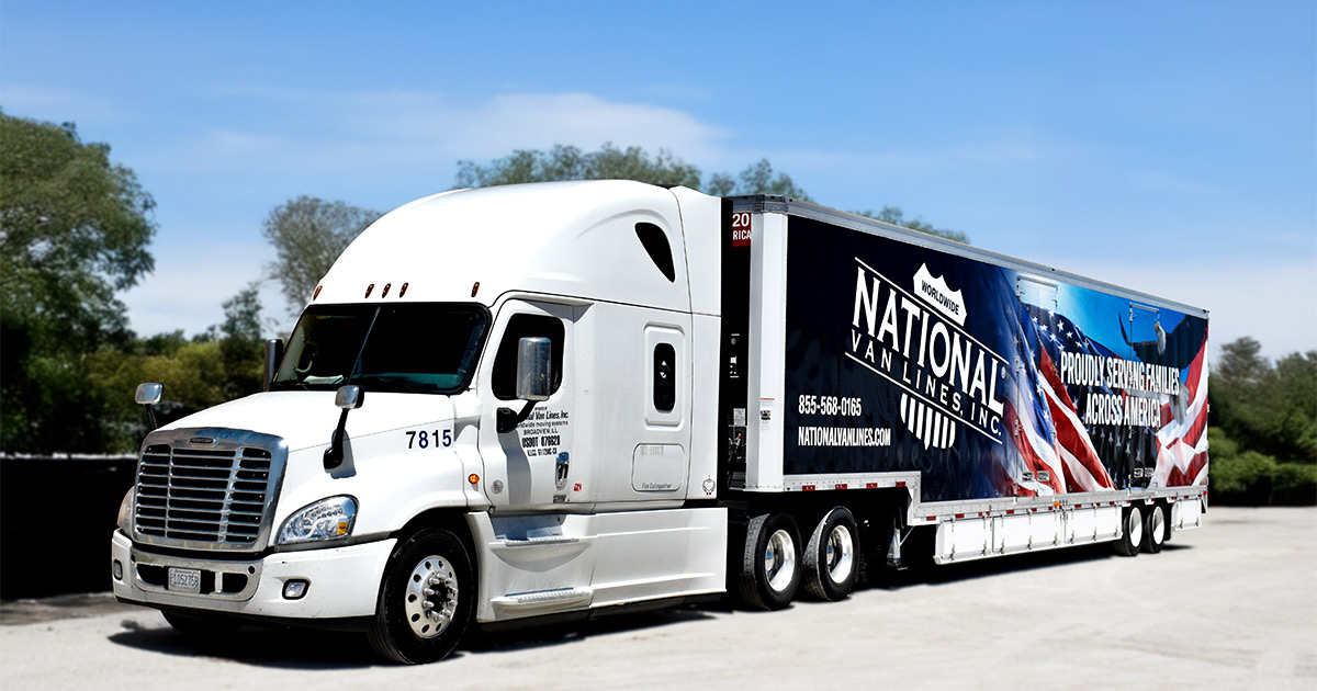 A National Van Line truck with a truck wrap that reads "proudly serving families across America", in reference to being a moving company for veterans. 