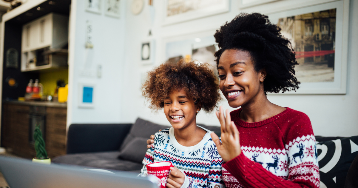 A mother and her child greet their family on a video call during holidays after their long distance move.