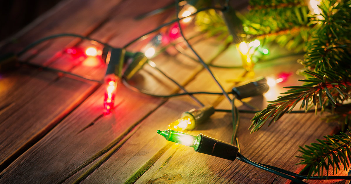 A strand of Christmas lights on a wooden table. 