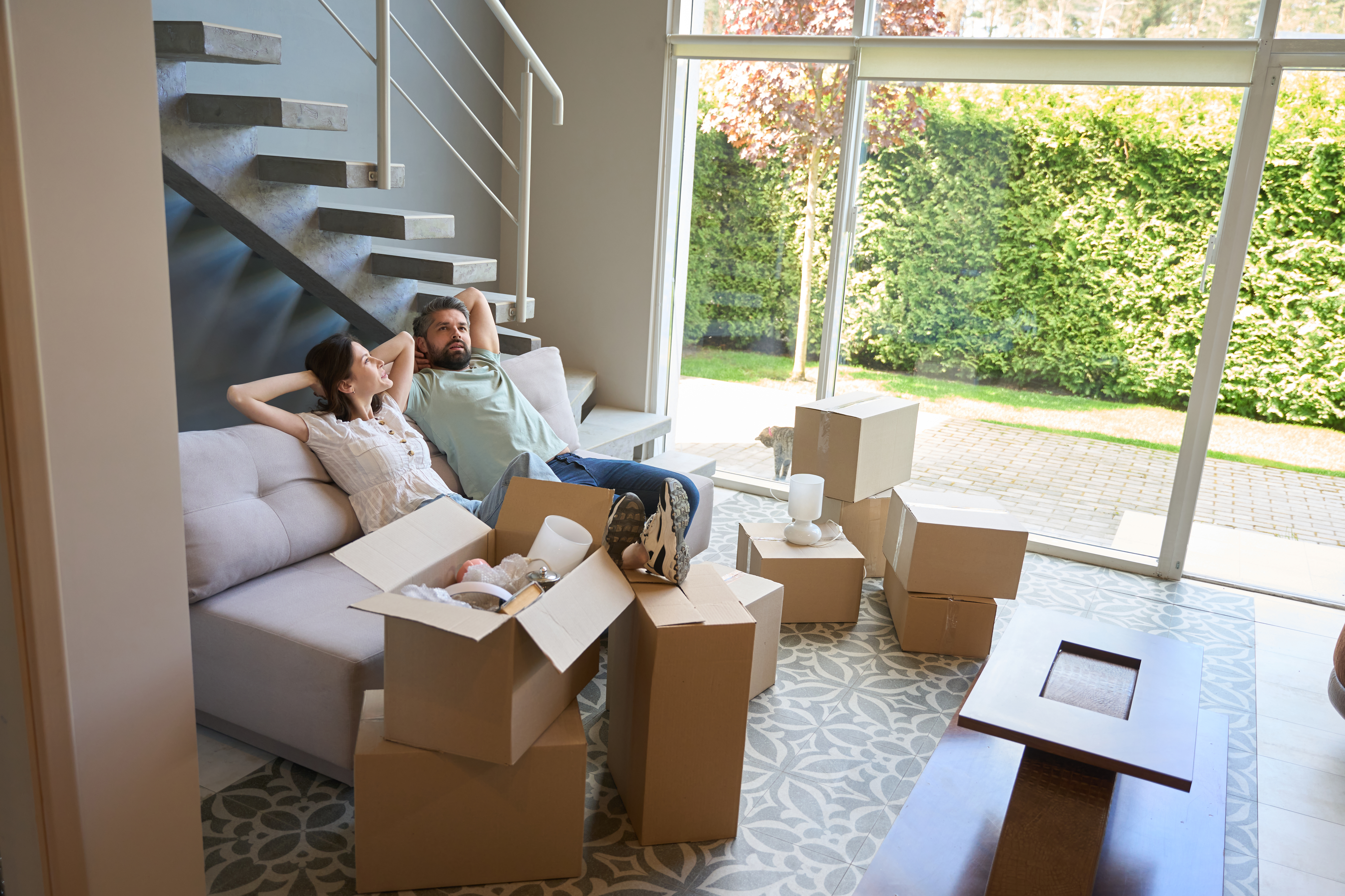 couple relaxing in living room after successfully moving in