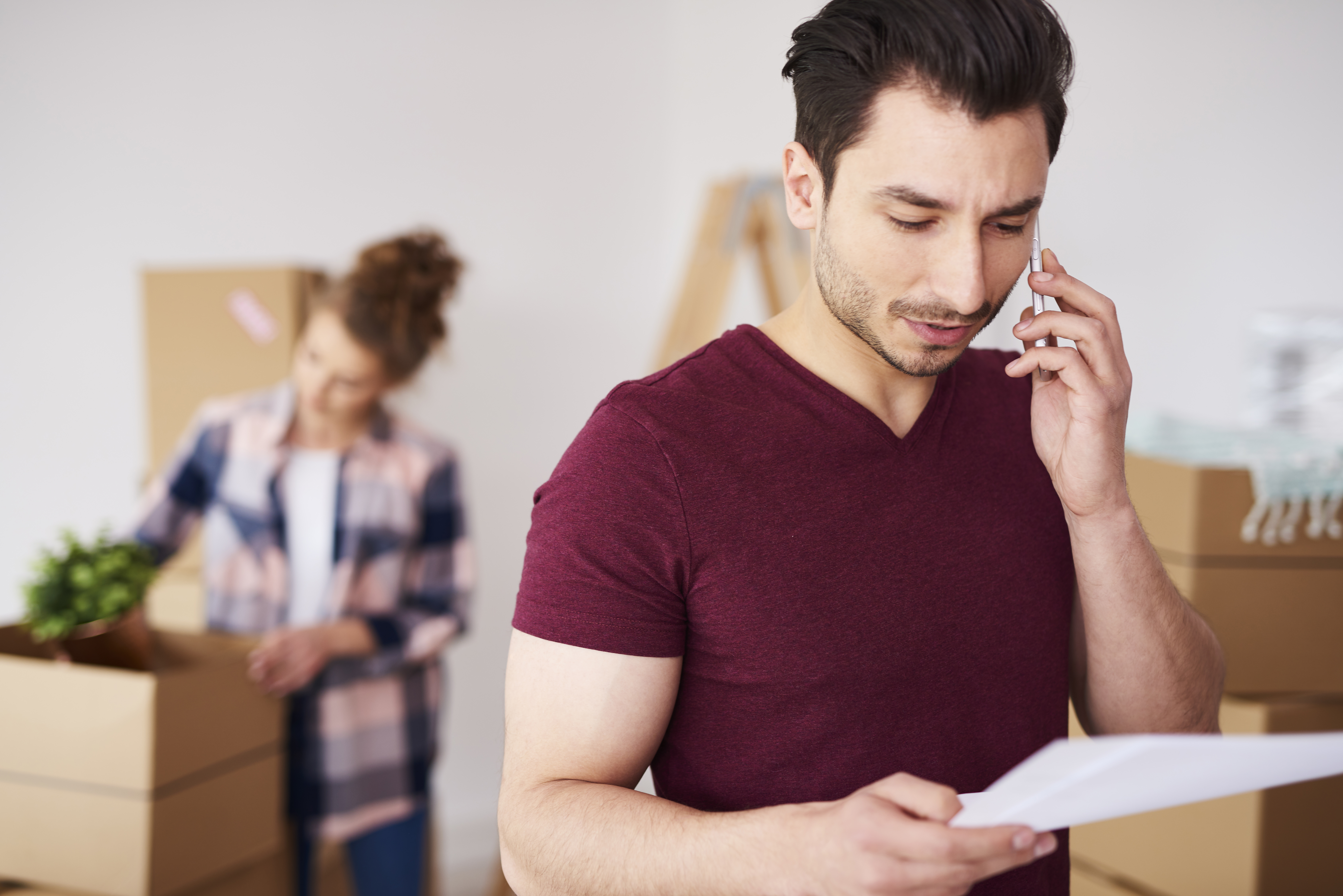 Man using phone to discuss moving quote with moving company