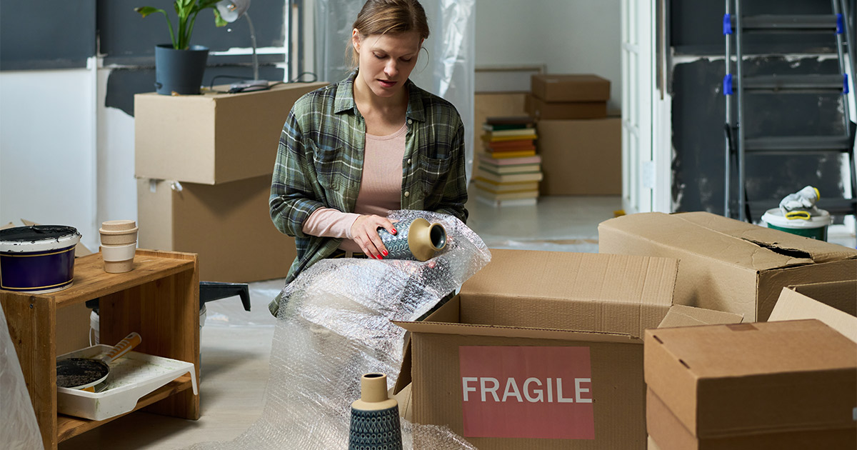 lady packing with bubble wrap getting ready to move