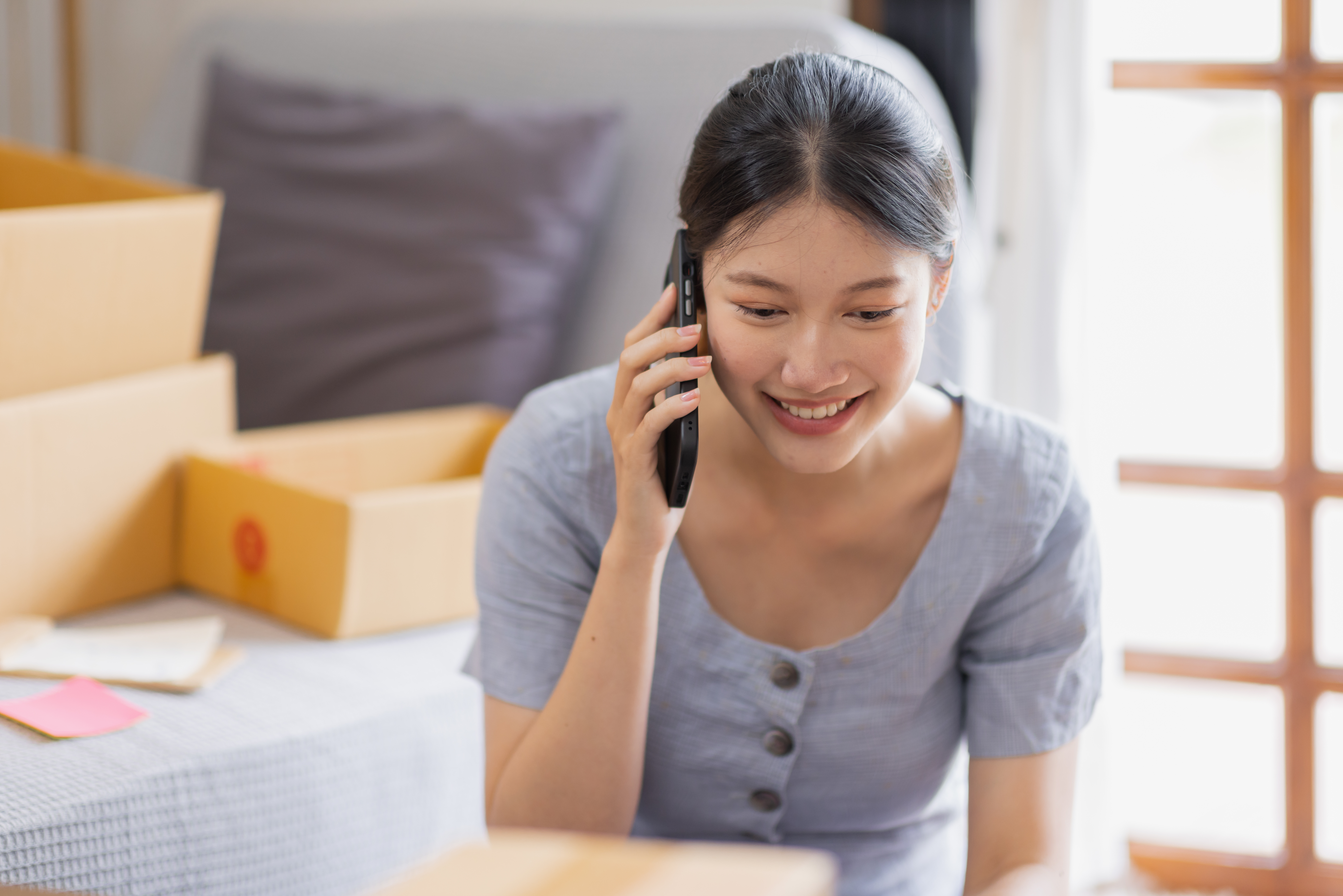 lady on phone while packing and moving